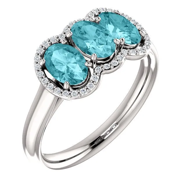 14KT GOLD 2.25 CTW BLUE ZIRCON & 0.10 CTW DIAMOND 3 STONE OVAL HALO RING