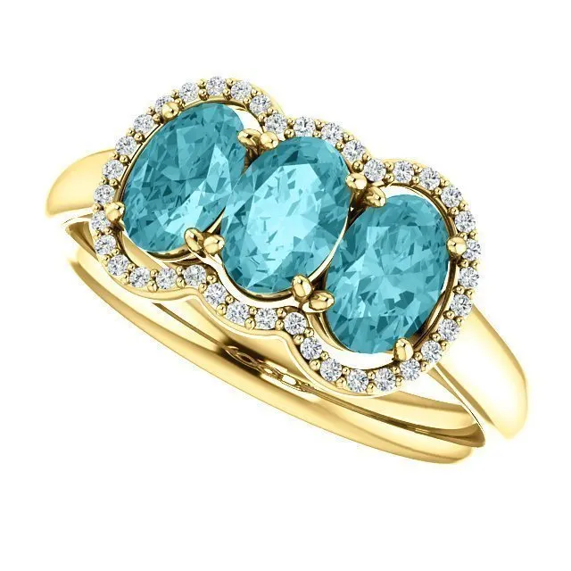 14KT GOLD 2.25 CTW BLUE ZIRCON & 0.10 CTW DIAMOND 3 STONE OVAL HALO RING