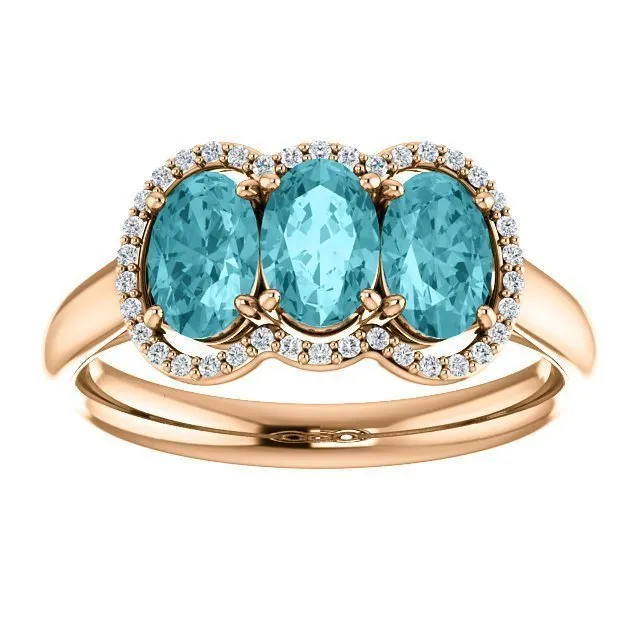 14KT GOLD 2.25 CTW BLUE ZIRCON & 0.10 CTW DIAMOND 3 STONE OVAL HALO RING