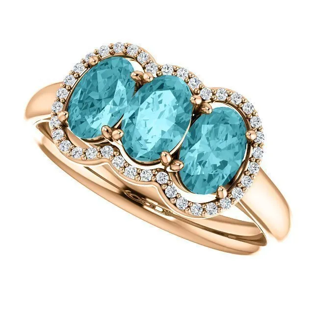 14KT GOLD 2.25 CTW BLUE ZIRCON & 0.10 CTW DIAMOND 3 STONE OVAL HALO RING