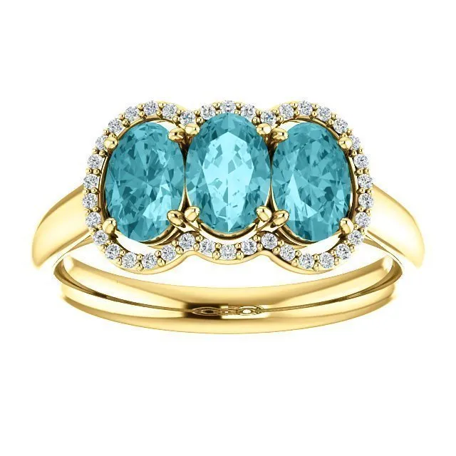 14KT GOLD 2.25 CTW BLUE ZIRCON & 0.10 CTW DIAMOND 3 STONE OVAL HALO RING